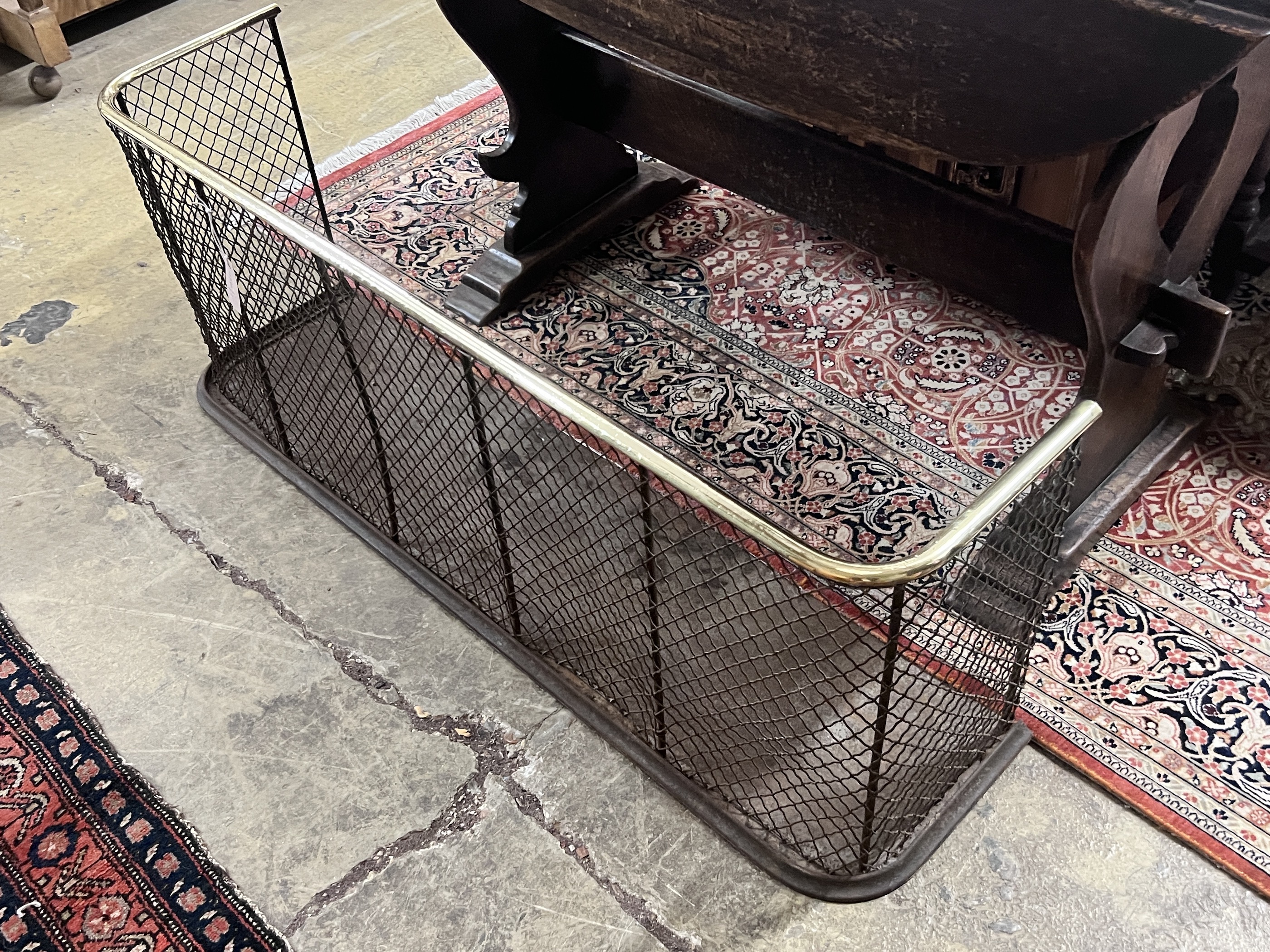 A Victorian brass mounted cast iron and mesh fender, width 122cm, depth 30cm, height 46cm